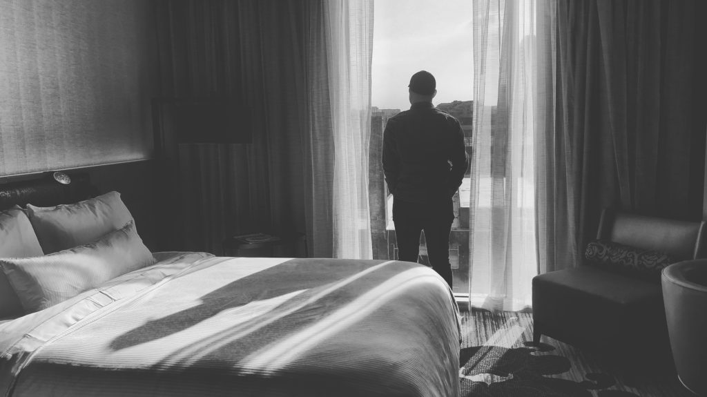 sexual-performance-anxiety-man-alone-in-bedroom-black-and-white